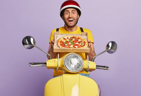 image of a delivery driver sitting on a scooter while holding a pizza box along with the DeliveryDart logo