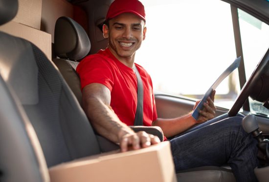 delivery truck driver smiling on duty with the DeliveryDart logo