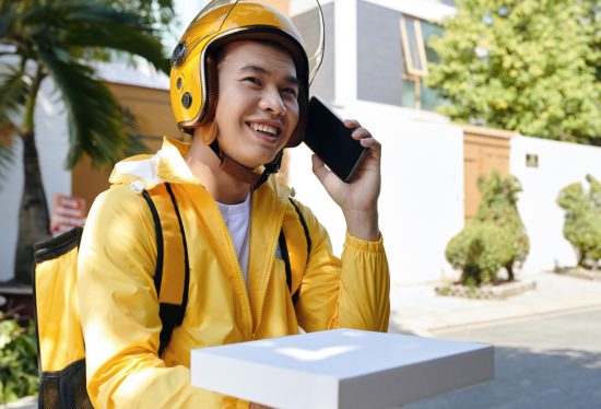 image of a delivery man calling a customer with DeliveryDart logo