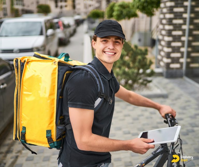 food delivery driver on duty sitting on a bike with a yellow bag and tablet along with the DeliveryDart logo