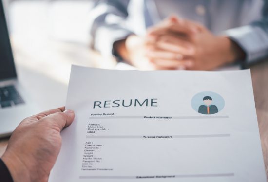 employee handing over delivery driver resume to employer