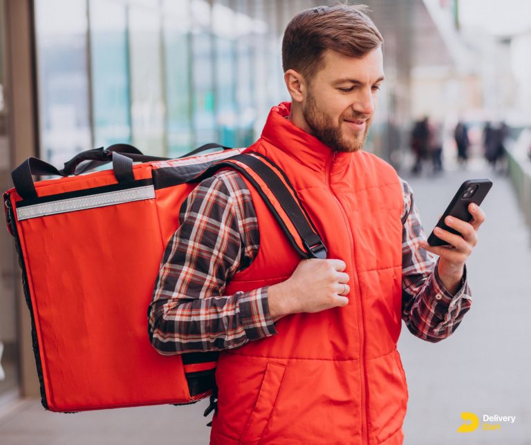 image of a delivery driver looking into his phone and smiling with DeliveryDart logo