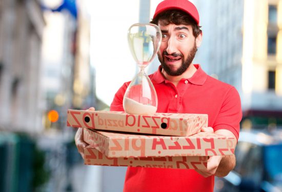 a man holding pizza boxes and an hour glass along with the DeliveryDart logo