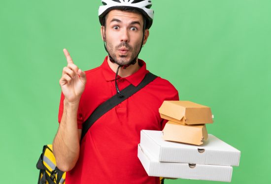 delivery driver holding items and pointing up with the DeliveryDart logo