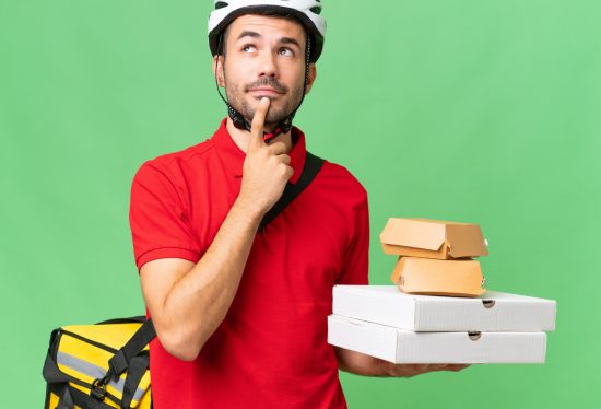 image of a delivery driver with delivery items and a delivery bag looking up as if he is thinking with the DeliveryDart logo