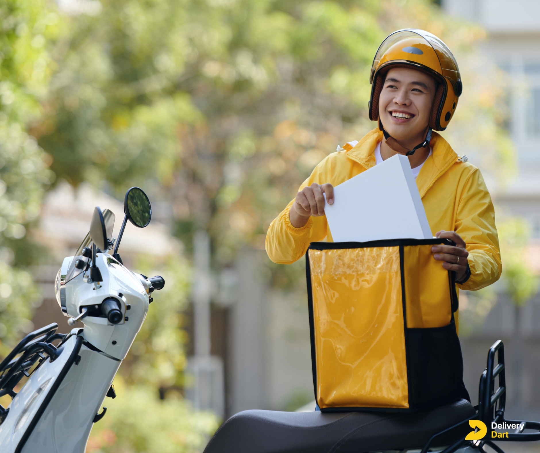 delivery driver putting delivery box into bag with DeliveryDart logo