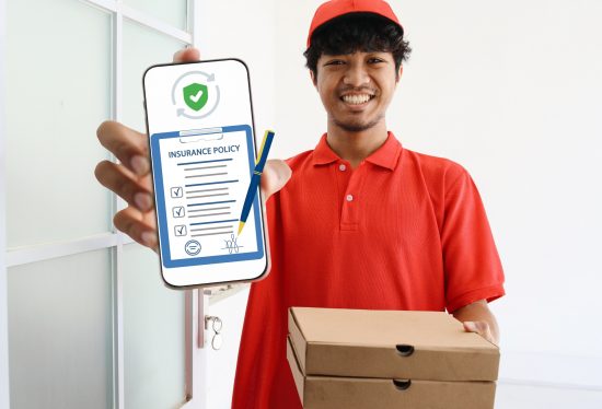 delivery driver holding a phone that shows delivery insurance along with DeliveryDart logo