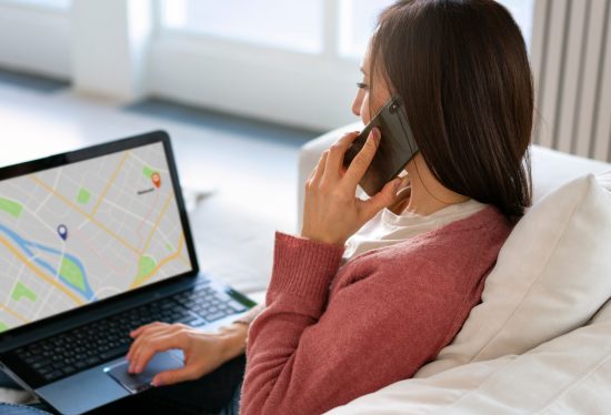 business woman checking gps tracker on laptop with DeliveryDart logo