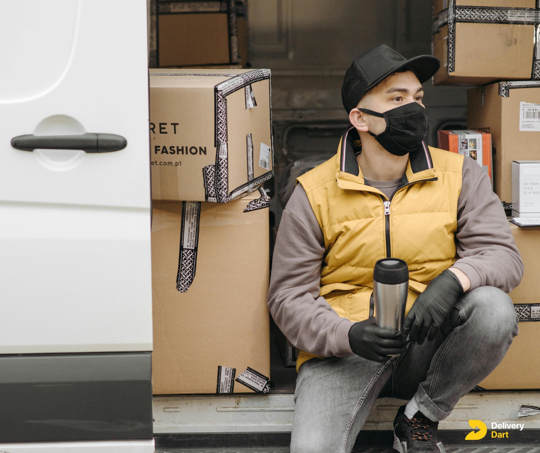 amazon delivery driver sitting on his truck with DeliveryDart logo