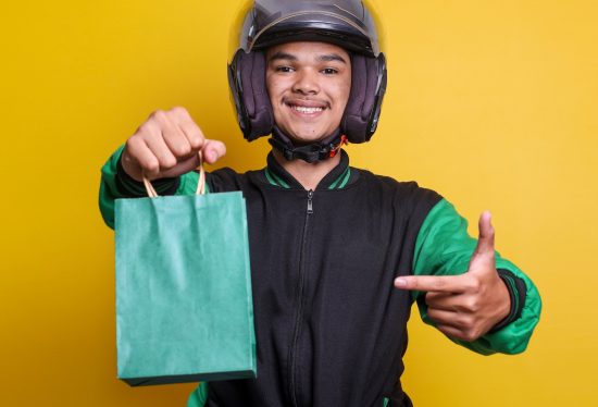 experienced delivery driver holding a bag along with DeliveryDart logo